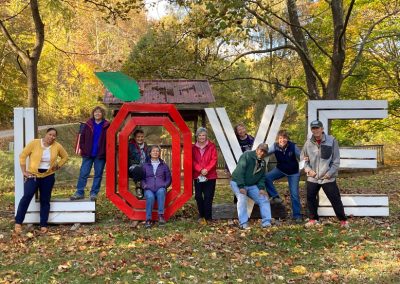 group of people sitting inside a LOVE sign